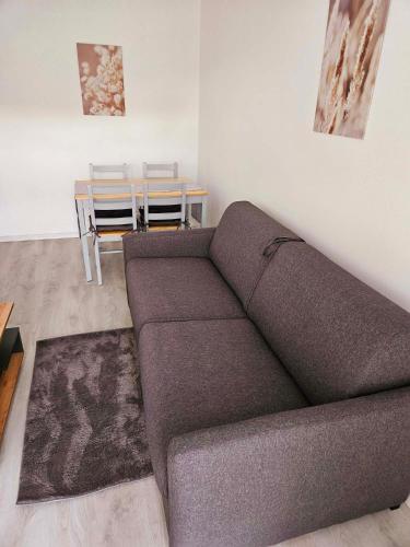 a living room with a couch and a table at Ferienwohnung Lottstetten in Lottstetten