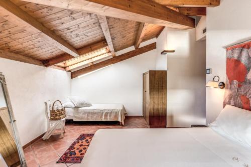a bedroom with a bed in a room with wooden ceilings at Casale Giancesare Villa Agricola in Capaccio-Paestum