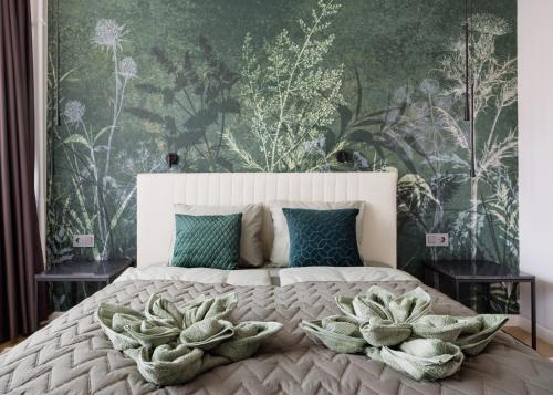 a bedroom with a large bed with a floral wallpaper at Designer's Retreat in Buda in Budapest