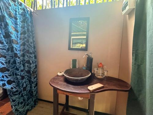 a bathroom with a sink on a wooden table at Selous River Camp in Kwangwazi