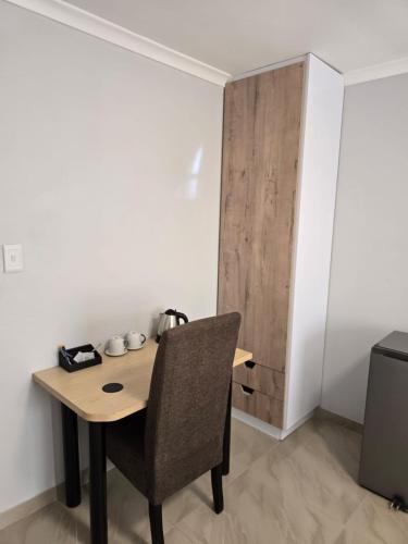 a room with a wooden table and a chair at Sekret Zone Hotel in New Germany
