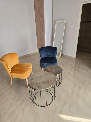 two chairs and a table in a room at Sekret Zone Hotel in New Germany