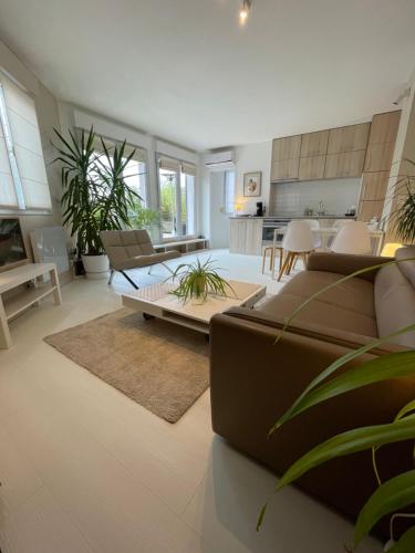 a living room with a couch and a table at Appartement ,superbe terrasse 40m2 , vieux Lille , centre ville in Lille
