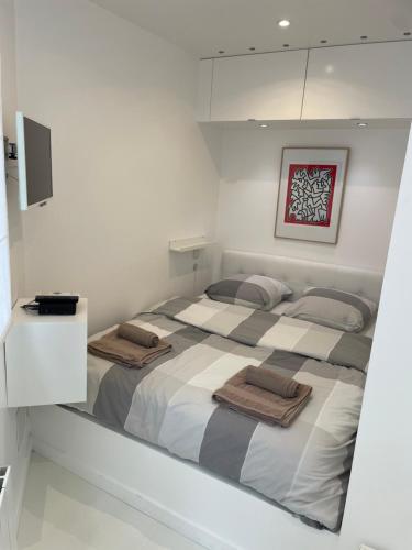 a bedroom with a large bed with towels on it at Appartement ,superbe terrasse 40m2 , vieux Lille , centre ville in Lille