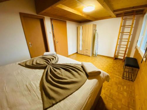 a bedroom with a bed with a blanket on it at Lake View Residence in Niederried