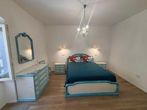 a bedroom with a bed and a dresser and a mirror at Villa Stefania in Magomadas