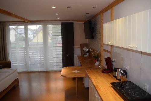 a kitchen with a wooden counter top in a room at Apartmenthaus Erlenbach in Erlenbach