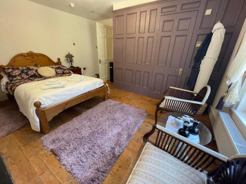 a bedroom with a bed and a purple door at Croft House Apartments in Hastings