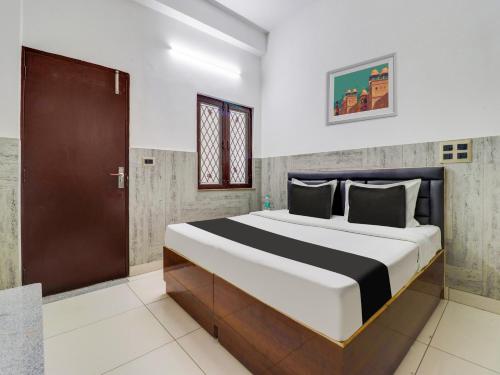a bedroom with a large bed in a room at Hotel O Gp Homestay in Dehradun