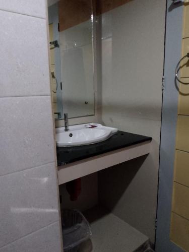 a bathroom with a sink and a mirror at Dante's Hideaway Guest House in Boracay