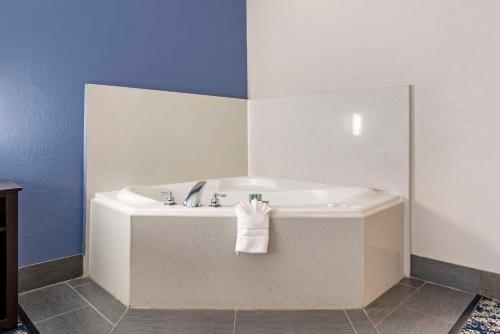 a bathroom with a bath tub with a towel on it at Best Western Canton Inn in Canton