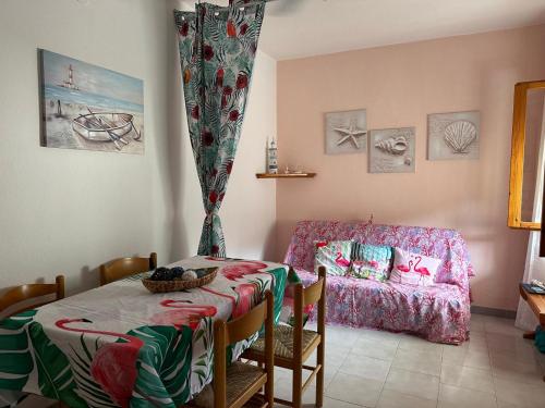 a living room with a table and a couch at Villaggio Malfidano in Buggerru
