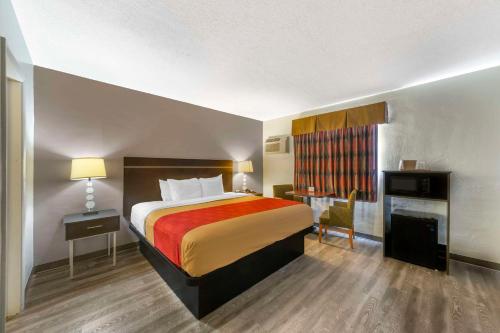 a hotel room with a bed and a desk at Fort Lauderdale Gardens Inn & Suites Ft Lauderdale International Airport in Hollywood