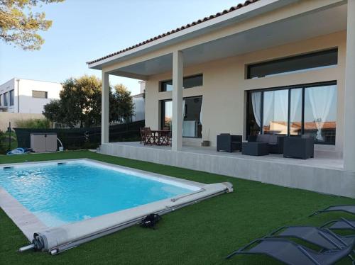 une piscine devant une maison dans l'établissement Villa spacieuse avec piscine, secteur très calme, à Nîmes