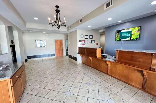 a lobby with a waiting area with a tv on a wall at Econo Lodge Augusta West near Fort Eisenhower in Augusta