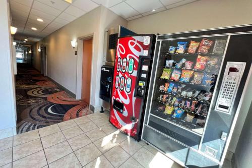 a cocacola refrigerator in a kitchen next to a hallway at Econo Lodge Augusta West near Fort Eisenhower in Augusta