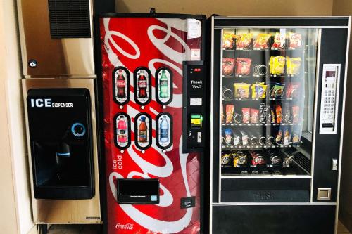a cocacola soda vending machine next to a wall at Econo Lodge Augusta West near Fort Eisenhower in Augusta