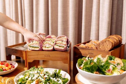 a table topped with plates of food and bowls of food at Hotel TOTTO Wollongong in Wollongong