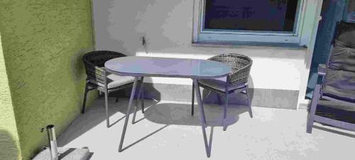 a purple table and two chairs in a room at Ferienwohnung Lottstetten in Lottstetten