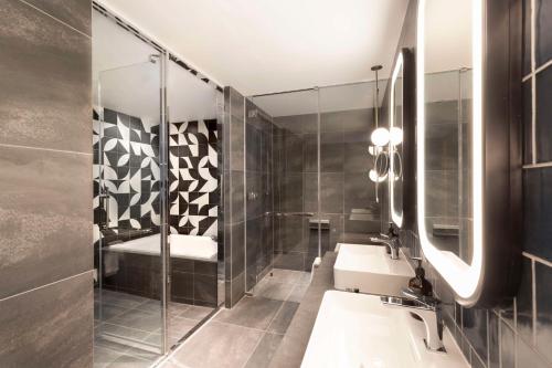 a bathroom with two sinks and a shower at Canopy By Hilton Osaka Umeda in Osaka