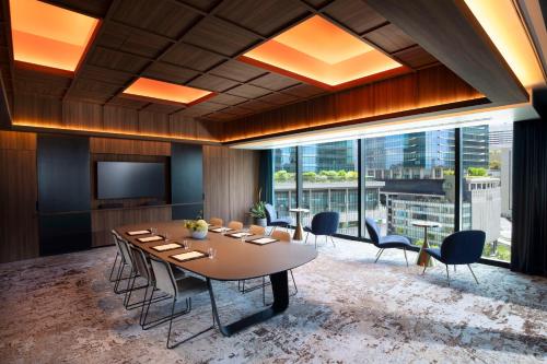 a conference room with a table and chairs and a television at Canopy By Hilton Osaka Umeda in Osaka
