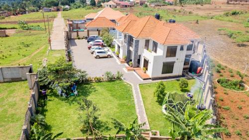 an aerial view of a house with cars parked in a yard at Blanket Suites in Kabubu