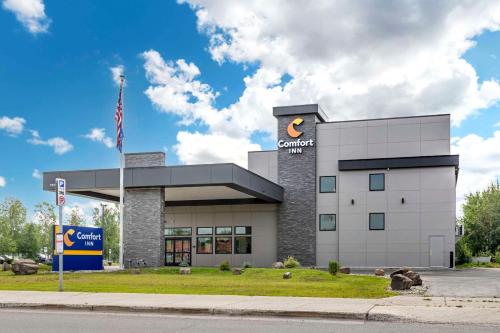 a building with an american flag in front of it at Comfort Inn Fairbanks in Fairbanks