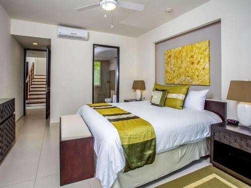 a bedroom with a large bed with a painting on the wall at Marival Distinct All-Suites & World Spa - Handwritten Collection in Nuevo Vallarta 