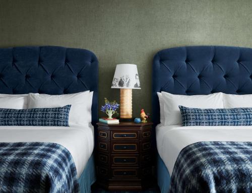 a bedroom with two beds and a lamp on a night stand at Graduate by Hilton Storrs in Storrs