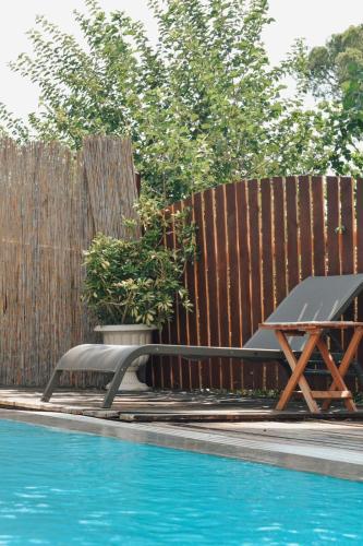 a picnic table next to a fence next to a swimming pool at La Sorella in Dalyan