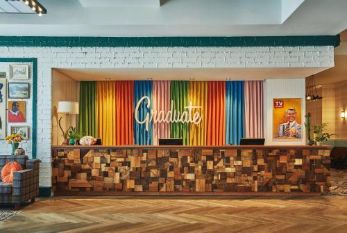 a lobby with a colorful wall with the word cincinnati at Graduate by Hilton Lincoln in Lincoln
