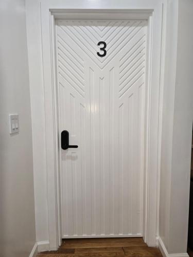 a white door with the number three on it at Beautiful Boston Bedroom - New Renovation in Boston