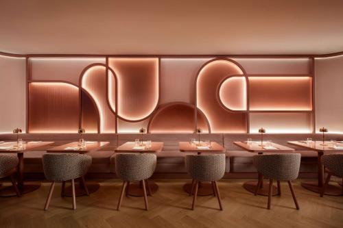 a row of tables and chairs in a restaurant at Revery Toronto Downtown, Curio Collection by Hilton in Toronto