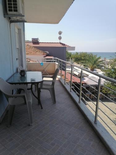 a balcony with a table and chairs and the ocean at POPI 'S HOME in Skala Sotiros