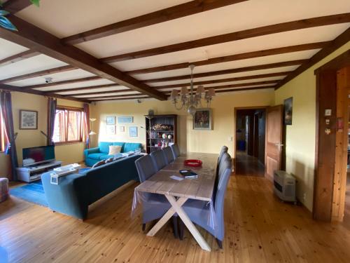 a living room with a table and a couch at Vakantiehuis Bourseigne in Gedinne