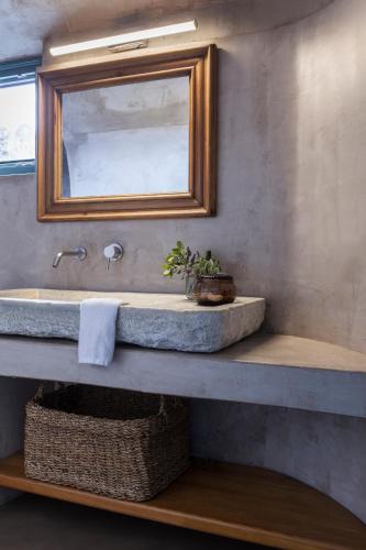 a bathroom with a sink and a mirror at Spitia Santorini Villa Collection in Oia