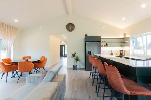a kitchen and living room with a couch and chairs at Kolmnurga Villa in Audru