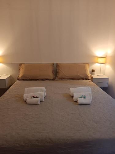 a bedroom with a bed with three pillows on it at Aniene Home Roma in Rome