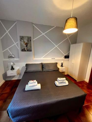 a bedroom with a bed with two towels on it at Aniene Home Roma in Rome