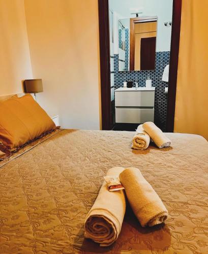 a bedroom with a bed with two towels on it at Aniene Home Roma in Rome