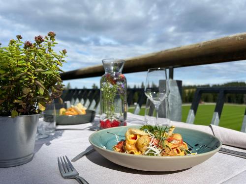 a table with a bowl of food on a table at Hotel Natura in Zreče
