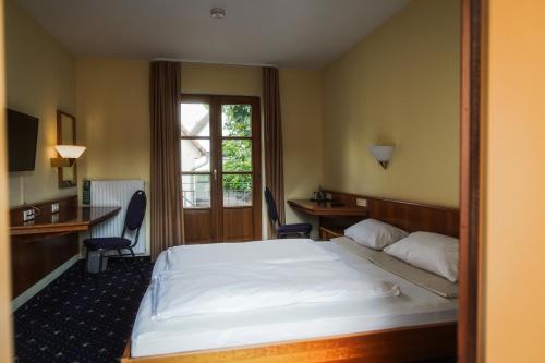 Ένα ή περισσότερα κρεβάτια σε δωμάτιο στο Hotel Erlenbacher Hof