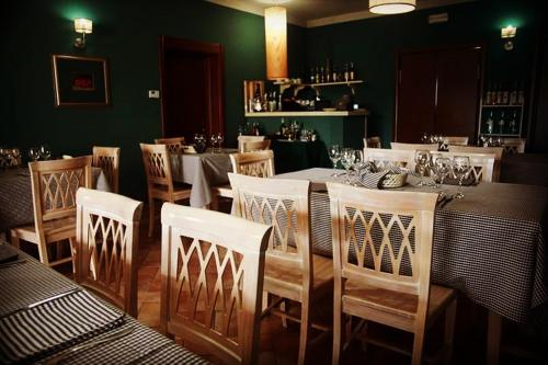 a dining room with a table and chairs at Oasi di Arcadia in Santa Giulia