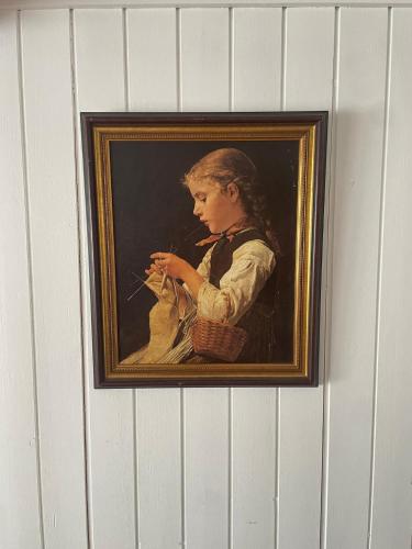 a painting of a girl with a basket on a wall at Charming Alpine Retreat By Apartments Capricorn in Gsteigwiler