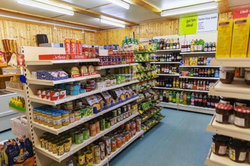 a grocery store aisle with shelves filled with food at Charming Alpine Retreat By Apartments Capricorn in Gsteigwiler