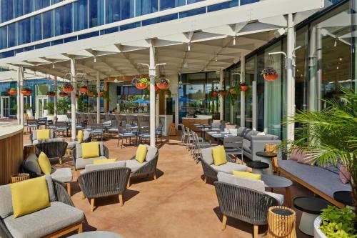 a patio with chairs and tables in a building at Walt Disney World Swan Reserve in Orlando