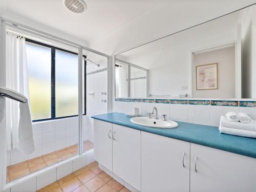 a white bathroom with a sink and a shower at Inji Homestead - 5 acre holiday home in Margaret river region in Yallingup