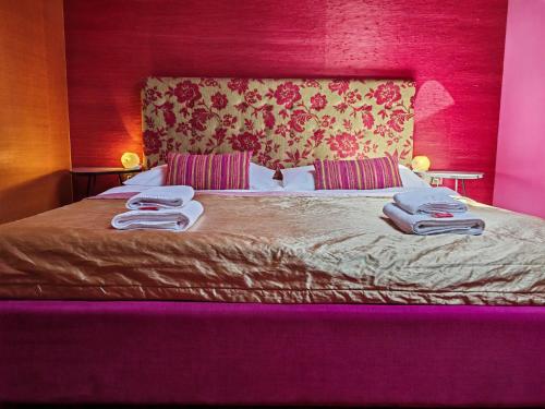 a bedroom with a bed with two towels on it at Hotel Rajská zahrada in Nové Město nad Metují