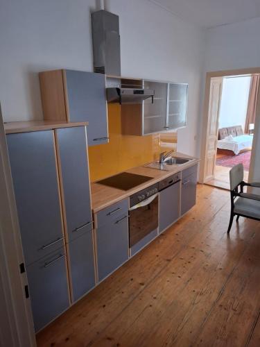 a kitchen with stainless steel appliances and a wooden floor at Madar Café Restaurant zum Fürsten in Melk