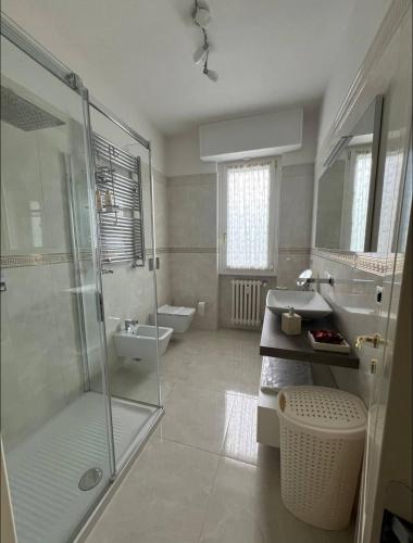 a bathroom with a shower and a sink and a toilet at Lenuare Luxury Apartment in Desenzano del Garda